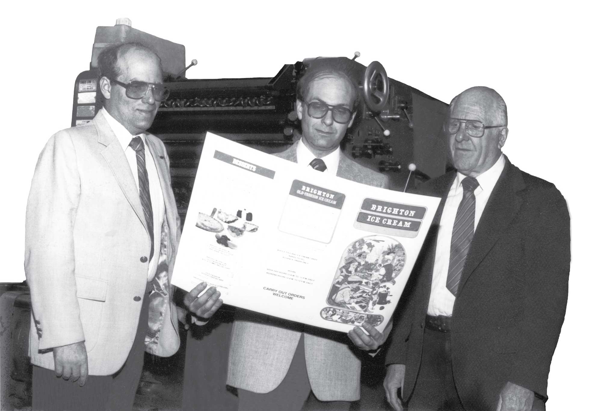 Three generations of the Jackson family — Eldon Jackson, Everett Jackson Jr., and Everett H. Jackson, Sr. — at a Franklin Printing press