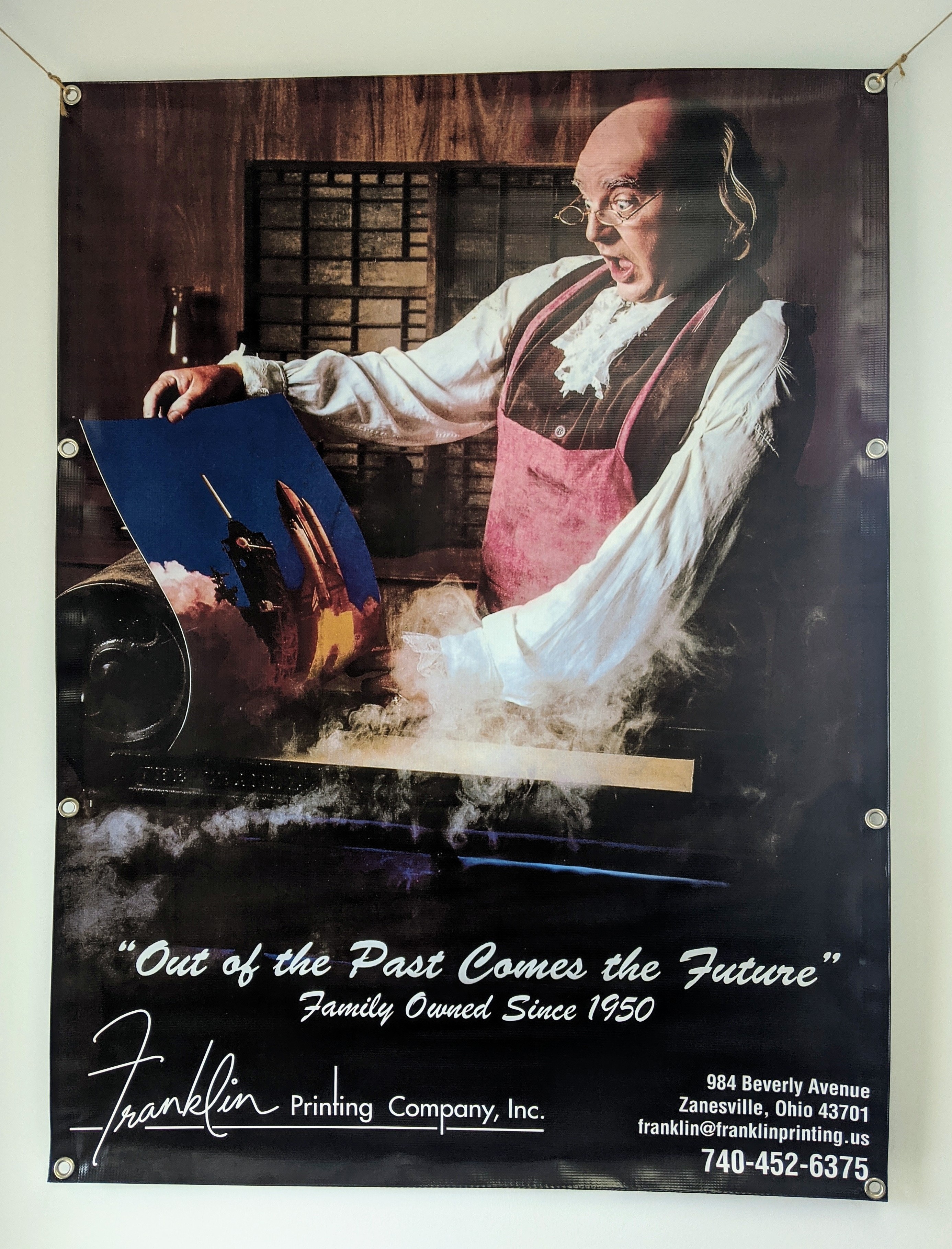Large grommeted vinyl banner of Benjamin Franklin pulling a print