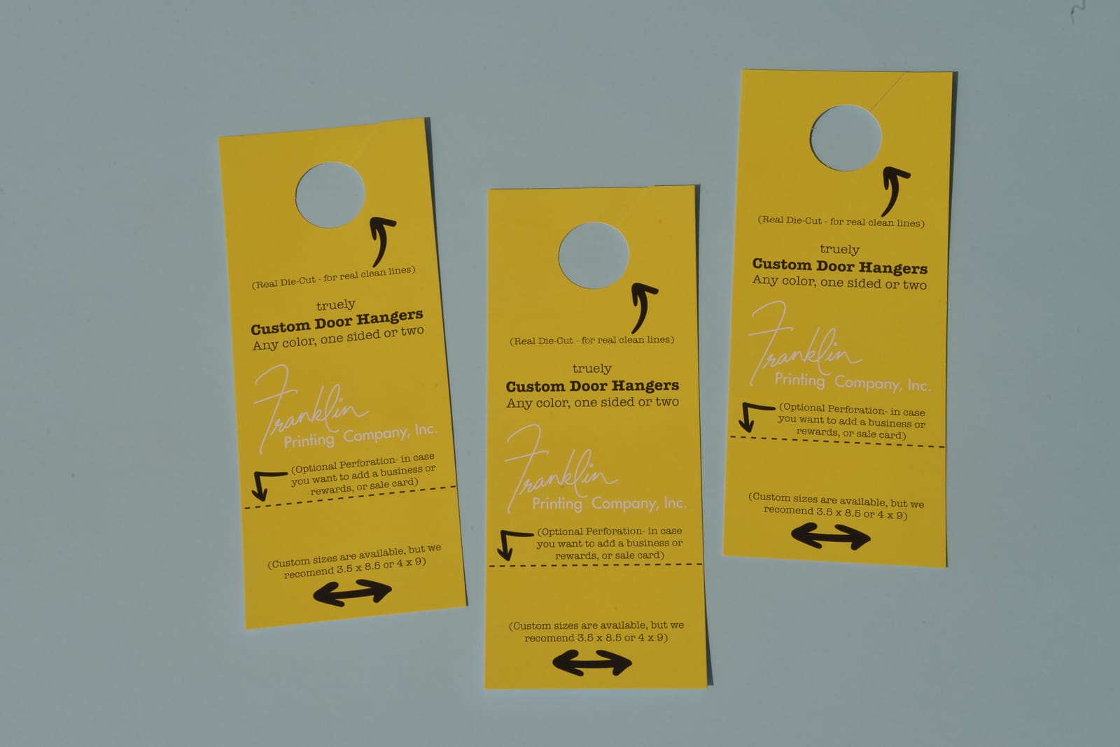 Three die-cut Franklin Printing door hangers with optional perforated tear-off cards