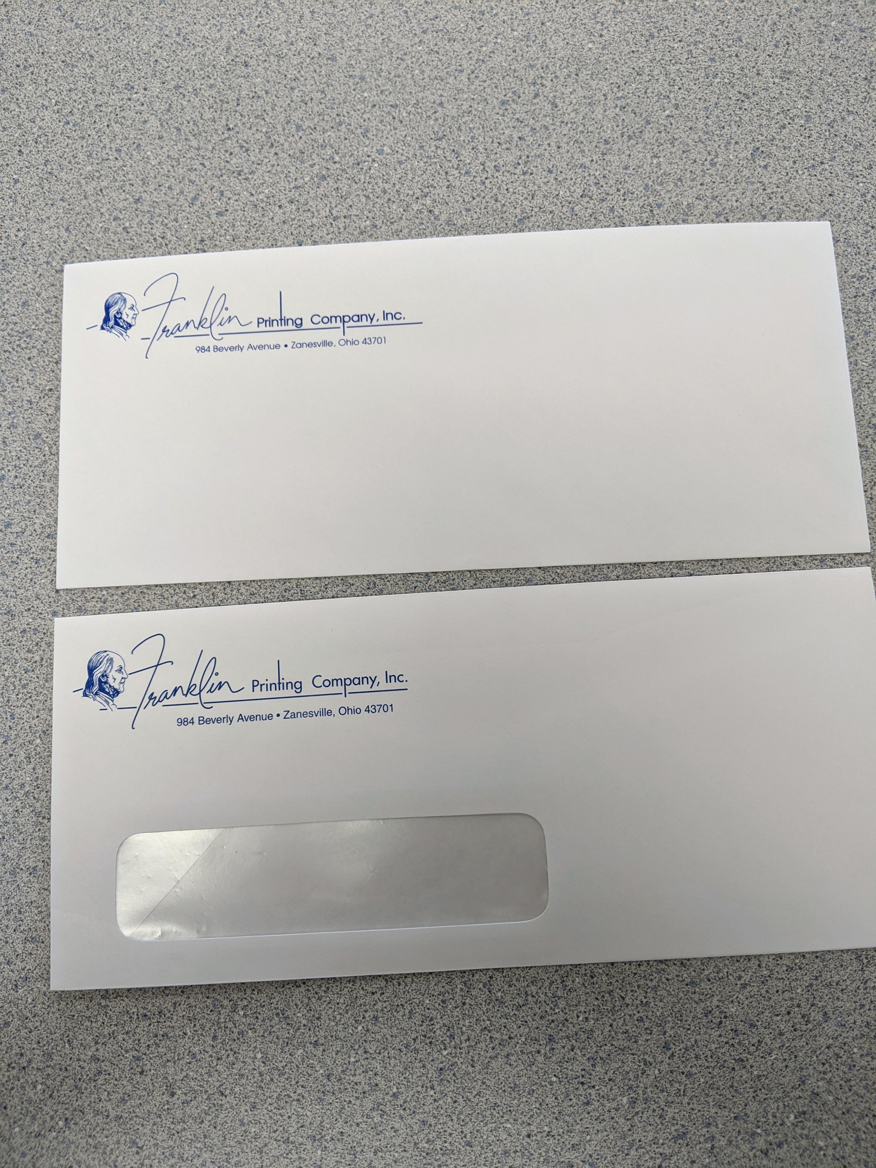 Two #10 Franklin Printing envelopes, one plain and one with a window