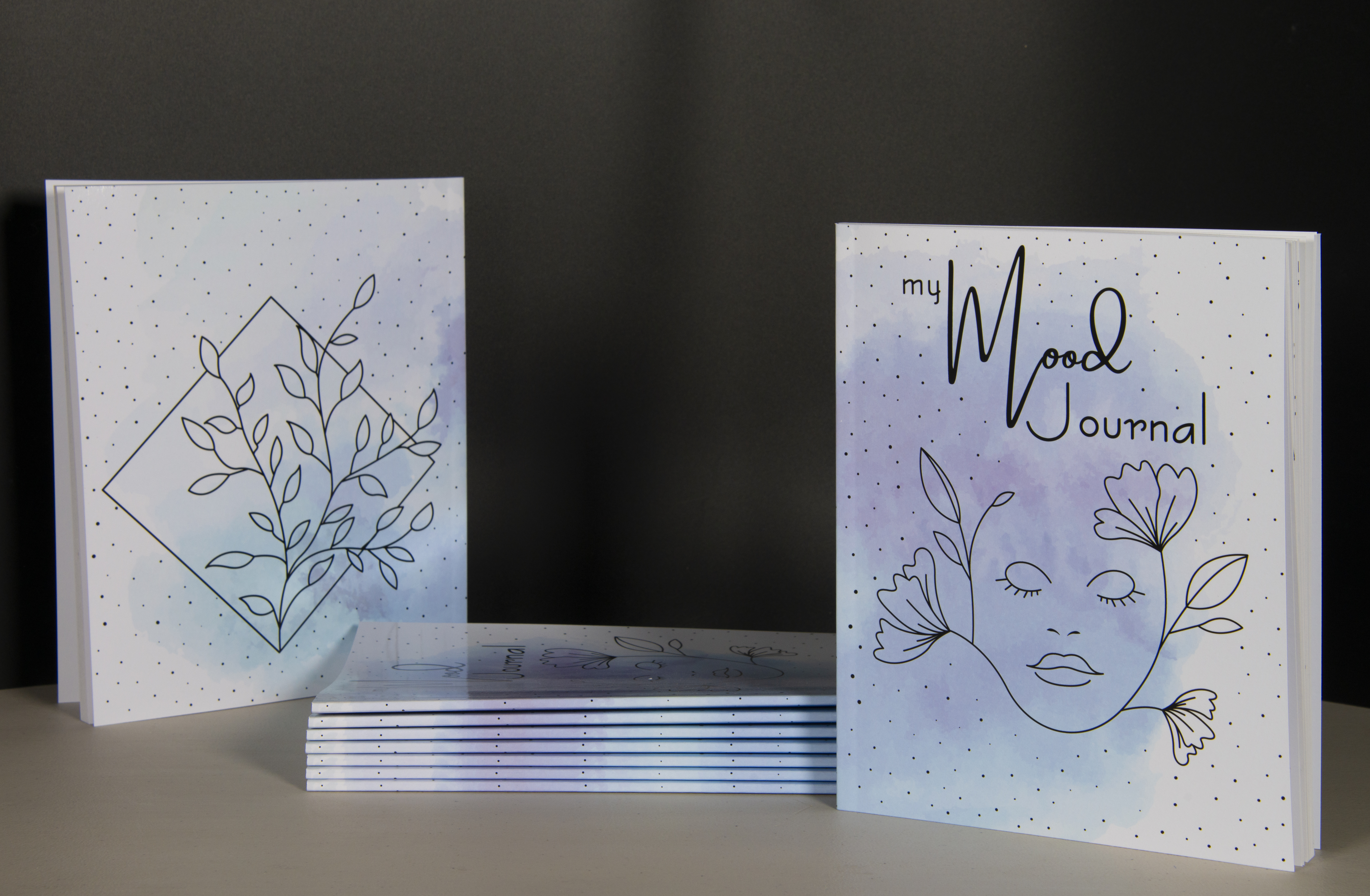 Stack of perfect-bound Mood journal booklets